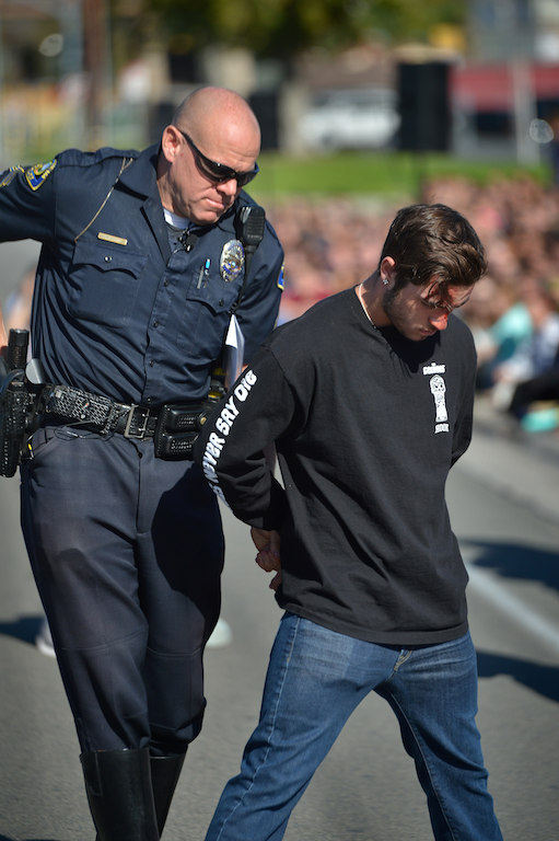 Students from Esperanza High School observe and participate in a program where a drunk driving related fatal car collision is staged in front of the school by Anaheim police and fire departments.