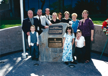 The Sowma family stands near a memorial outside the Cypress Police Department that honors fallen Sgt. Don Sowma. 