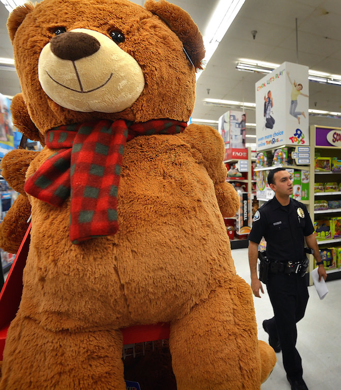 Joseph Martinez of the Signal Hill Police Department walks through the Toys R Us in Tustin at 6am looking for toys as police officers who recently graduated from Golden West Criminal Justice Training Center take their leftover funds from their dues and by $1,700 of toys for CHOC kids. Photo by Steven Georges/Behind the Badge OC