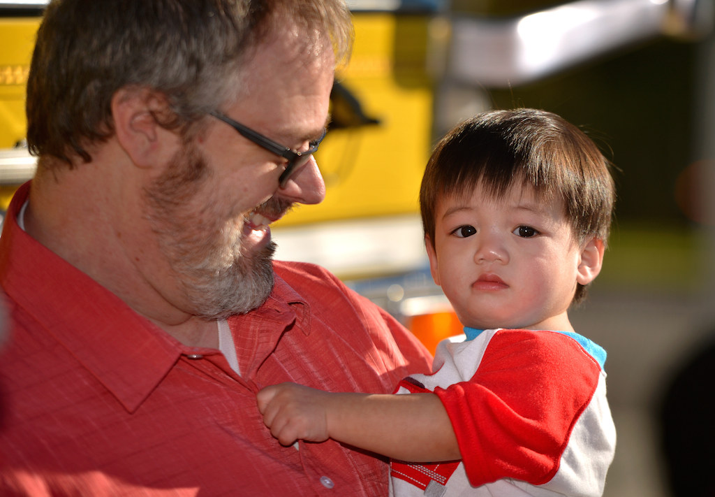 Christopher holds his son Caleb. Photo by Steven Georges/Behind the Badge OC