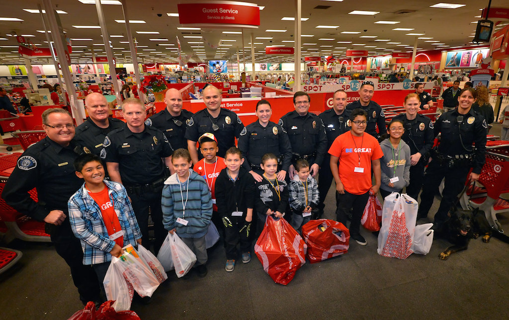 Members of the Cypress Police Department gather with the kids they partnered with at the Target store in Cypress for a Shop with a Cop Christmas event. Photo by Steven Georges/Behind the Badge OC
