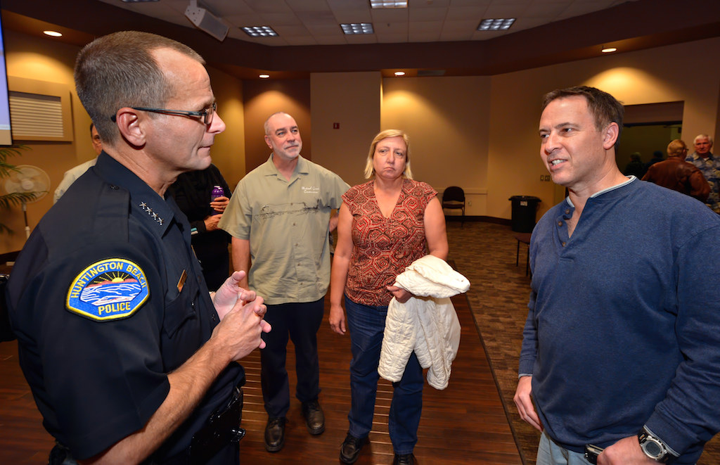 Huntington Beach Police Chief Robert Handy, left, answers questions for people gathered after a presentation on ‘Use of Force’ at the Huntington Beach Central Library that includes Huntington Beach citizens Karen Sears, second from right, and Bruce Wareh, right. Photo by Steven Georges/Behind the Badge OC