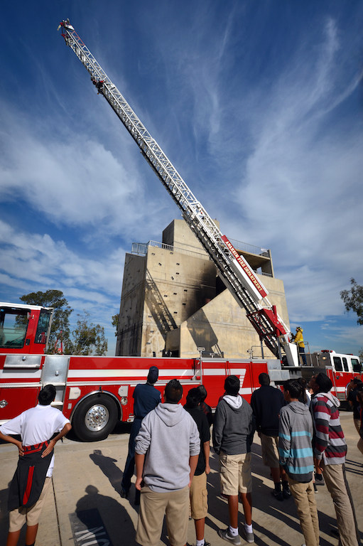 Sycamore Jr. High students watch as Anaheim Fire & Rescue firefighters extend a ladder from Anaheim Truck 6. Photo by Steven Georges/Behind the Badge OC