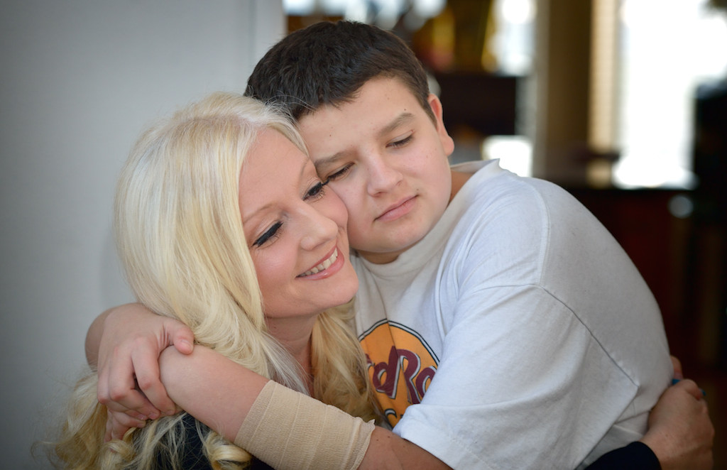 Dylan Baylos, 11, hugs his mom, Loretta, a cervical cancer survivor. Photo by Steven Georges/Behind the Badge OC