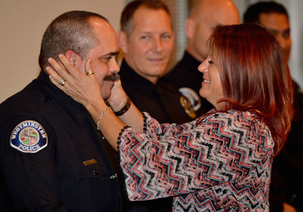 Cmdr. Mike Chapman of the Westminster PD is congratulated by his wife during a promotion ceremony at the Rose Center in Westminster. Photo by Steven Georges/Behind the Badge OC