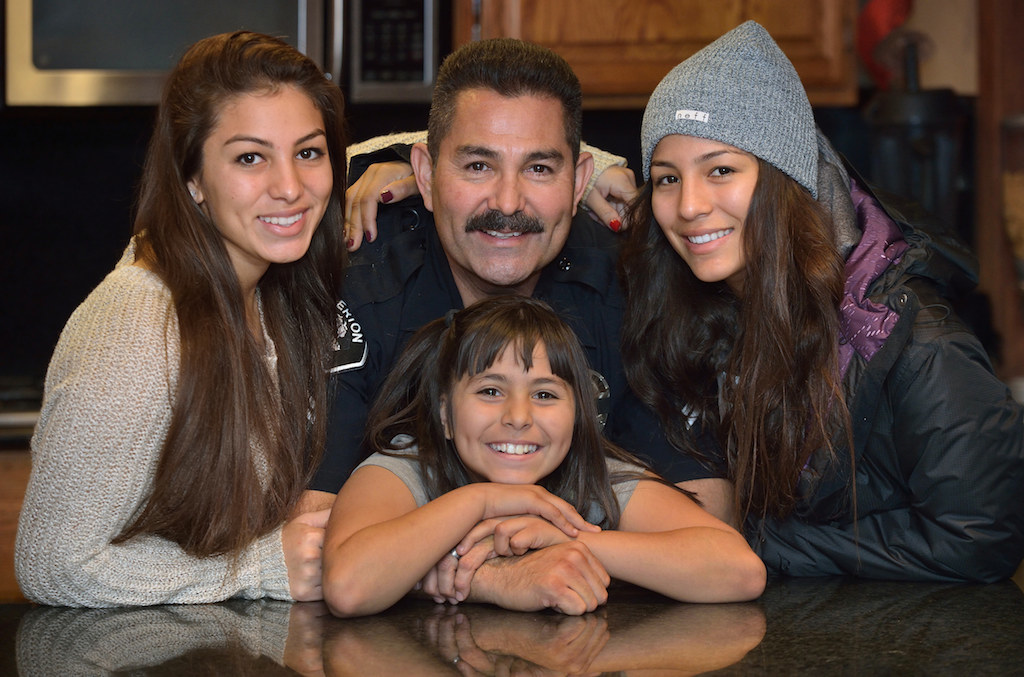 Flores with his daughters (from left)  Erin, Gabrielle and Amanda. Photo: Steven Georges