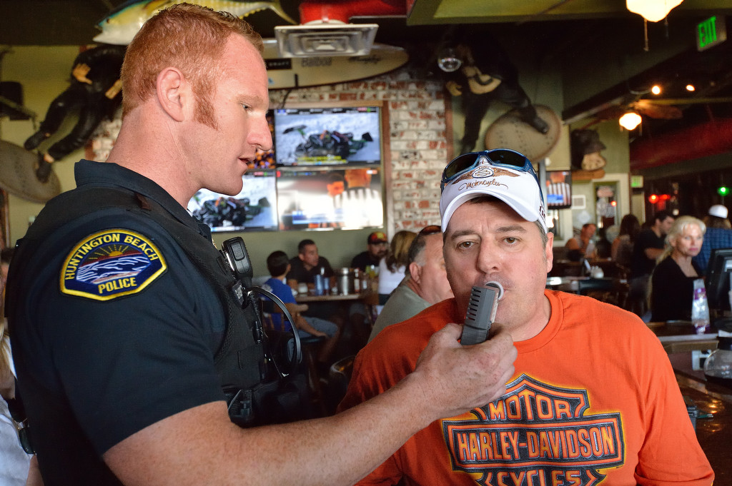 Huntington Beach Police visit bars in Sunset Beach to offer sobriety tests to volunteers as a public service message for those willing to participate, part of the "Sunday Funday" Know Your Limit campaign.