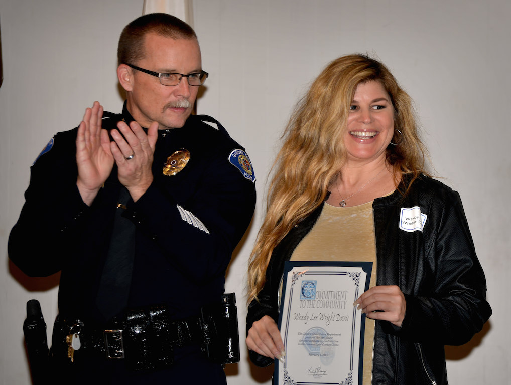 Elgin applauds a smiling Wendy Lee Wright Davis, who reported a man committing a lewd act in a truck in front of her house. Photo: Steven George 