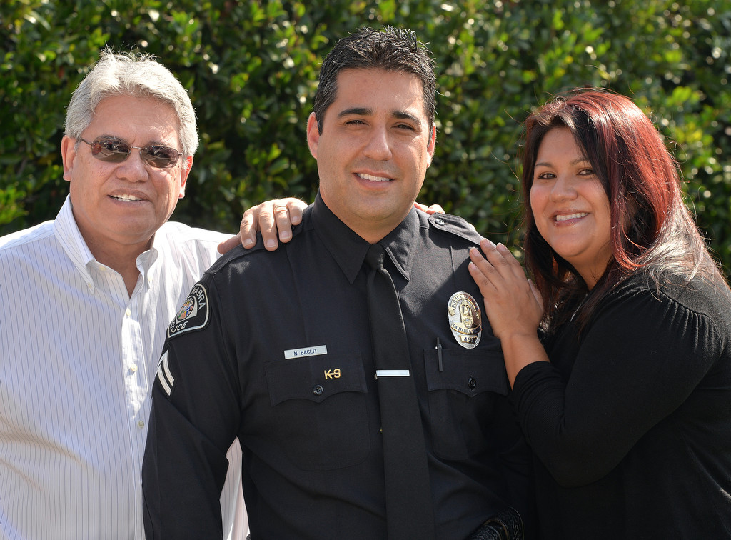 The 2014 La Habra Officer of the Year, Corporal Nick Baclit, center, with his father Carl Baclit and his wife of 9 years Marlena Baclit. Photo by Steven Georges/Behind the Badge OC