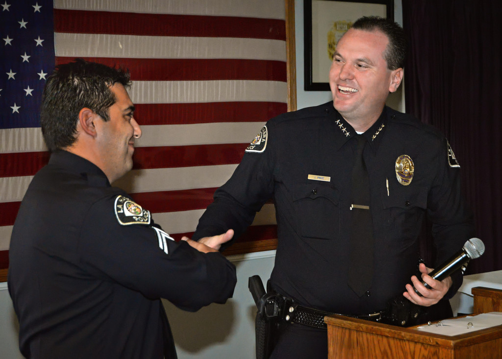 La Habra Police Corporal Nick Baclit, left, accepts the Officer of the Year award from Police Chief Jerry Price during a ceremony at the Elks Lodge in La Habra. Photo by Steven Georges/Behind the Badge OC