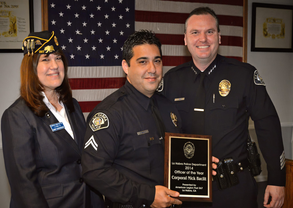 La Habra Police Corporal Nick Baclit, center, receives the Officer of the Year award from American Legion Post 267 Second Vice Commander Sandy Schneeberger, left, and Police Chief Jerry Price during a ceremony at the Elks Lodge in La Habra. Photo by Steven Georges/Behind the Badge OC