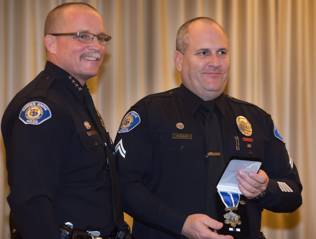 Corp. Timothy Kovacs (right) receives the Medal of Courage from Chief Todd Elgin. Photo by Steven Georges/Behind the Badge OC