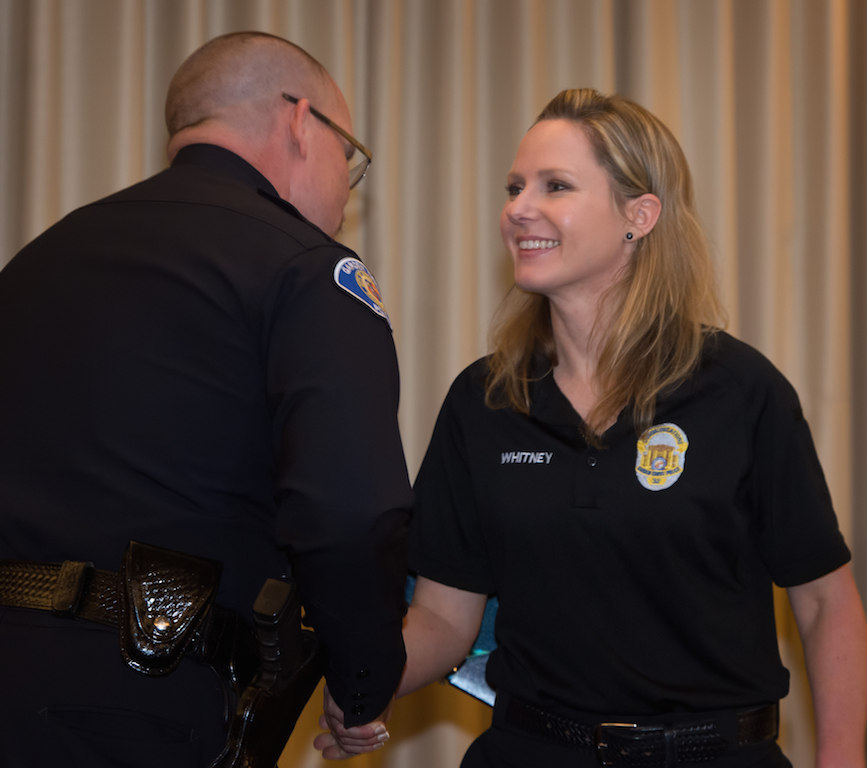 Chief Todd Elgin congratulates 2014 Civilian of the Year, Dispatcher Cheryl Whitney.