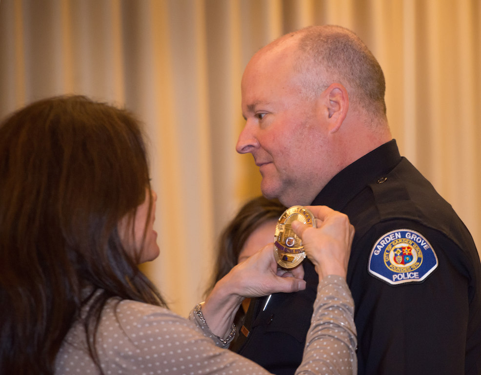 Lt. Christopher Lawton has his new badge pinned to him by his wife. Photo:  Steven Georges