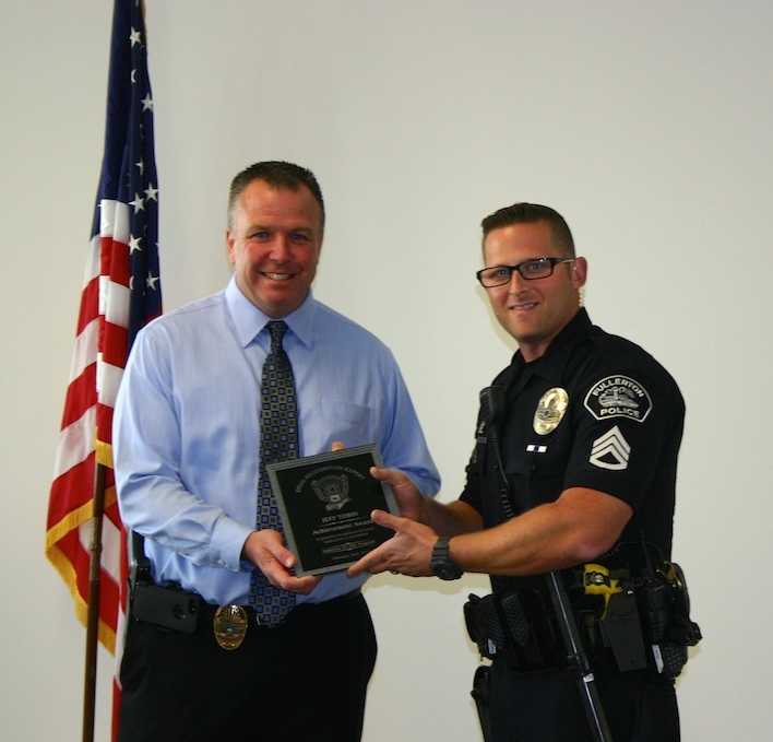 Sgt. Matt Ziemba (left) accepts the Jeff Tobin Award on behalf of Jeff’s wife, Laurie Ann ,given by Sgt. Radus. Photo by Stacy Schwed/Behind the Badge OC