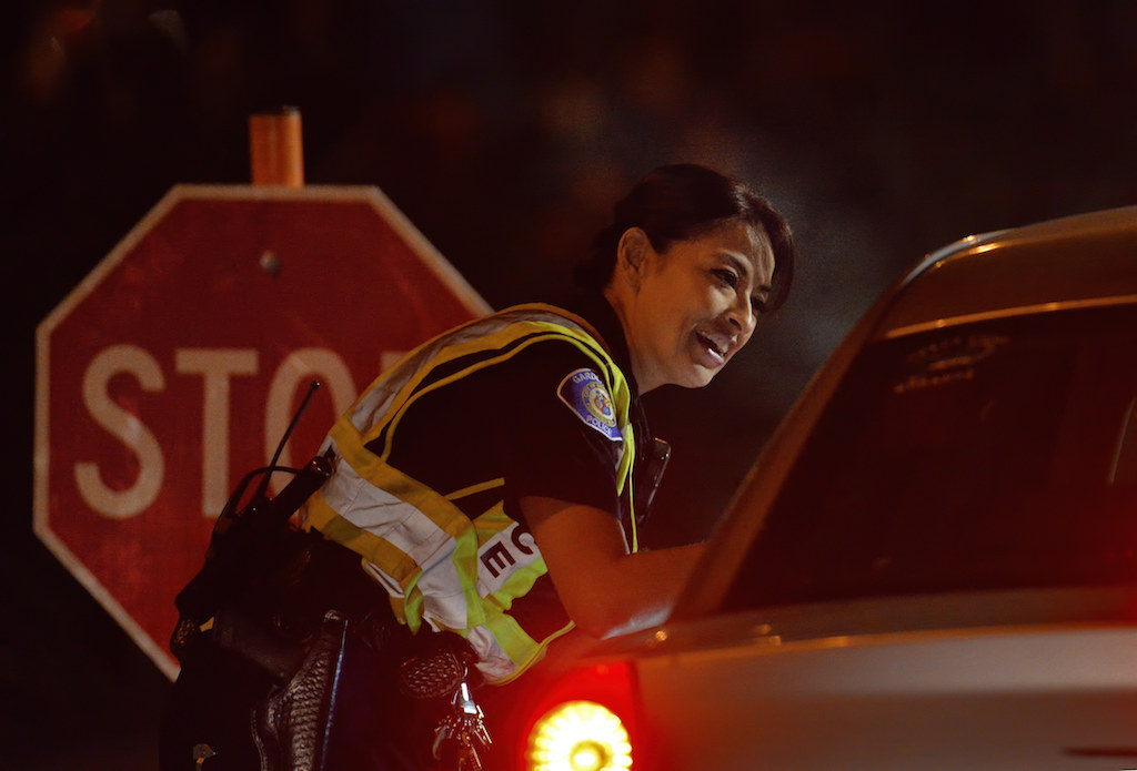 Officer Kathy Anderson of the Garden Grove PD assesses whether a driver should be further evaluated for possible DUI while checking for driver licenses at a checkpoint on Harbor Boulevard near Chapman Avenue on Feb. 13. Photo by Steven Georges/Behind the Badge OC