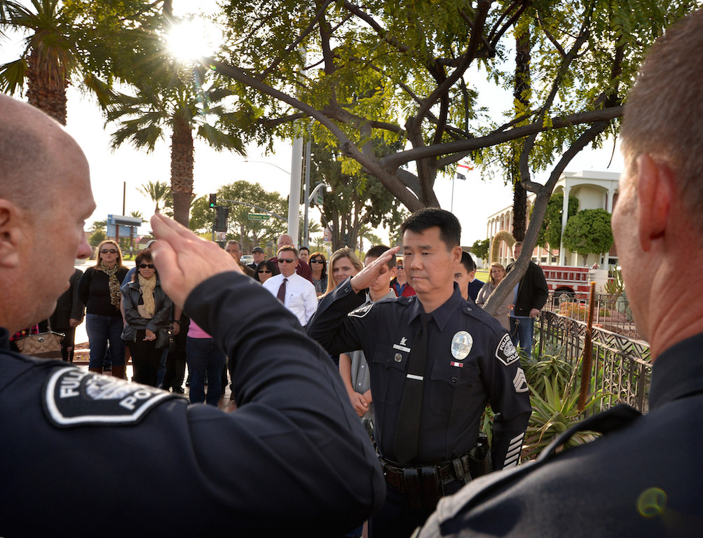 Fullerton PD Chief Dan Hughes, left, salutes Sgt. Tak Kim during Kim’s retirement ceremony after 32 years of service. Photo by Steven Georges/Behind the Badge OC