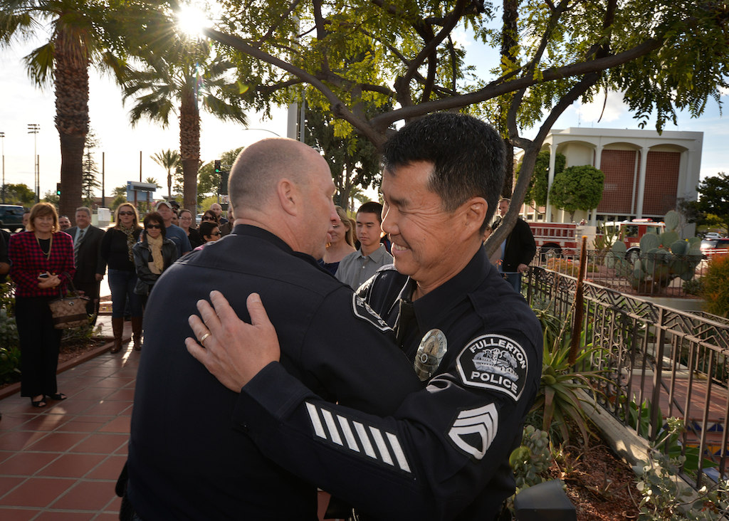 Sgt. Tak Kim, right, gets a hug from Fullerton PD Chief Dan Hughes during Kim’s retirement ceremony after 32 years of service. Photo by Steven Georges/Behind the Badge OC