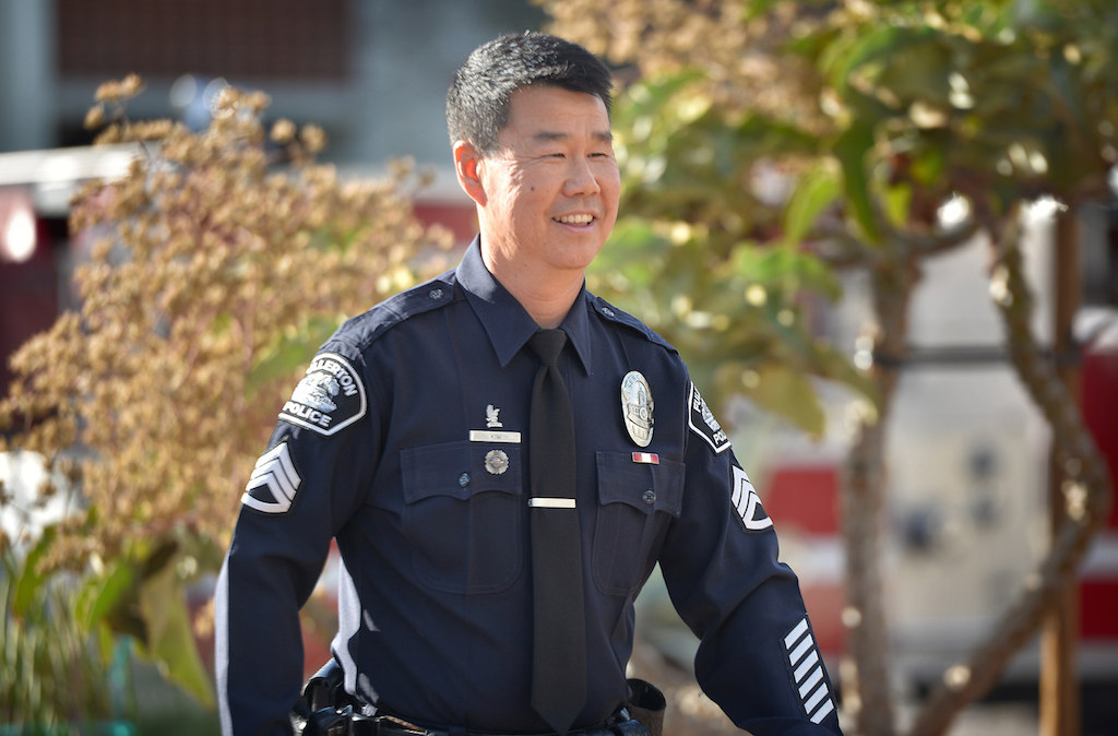 Fullerton Police Sgt. Tak Kim approaches the gathering at FPD’s headquarters for his retirement ceremony after 32 years of service. Photo by Steven Georges/Behind the Badge OC