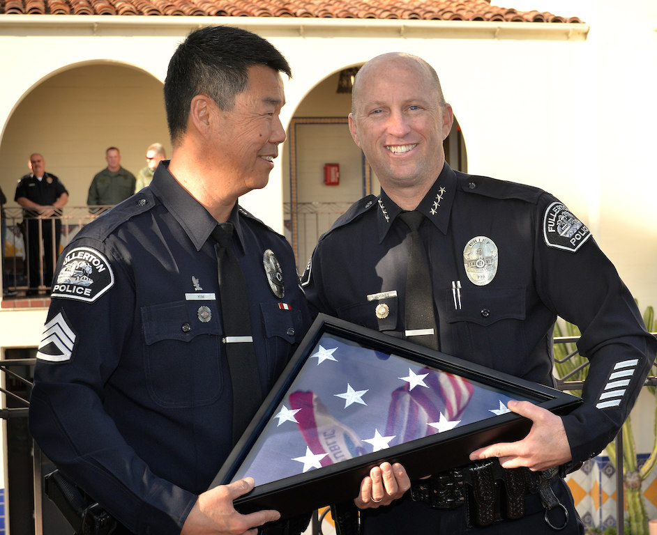Sgt. Tak Kim, left, with Fullerton Police Chief Dan Hughes during Kim’s retirement ceremony after 32 years of service. Photo by Steven Georges/Behind the Badge OC