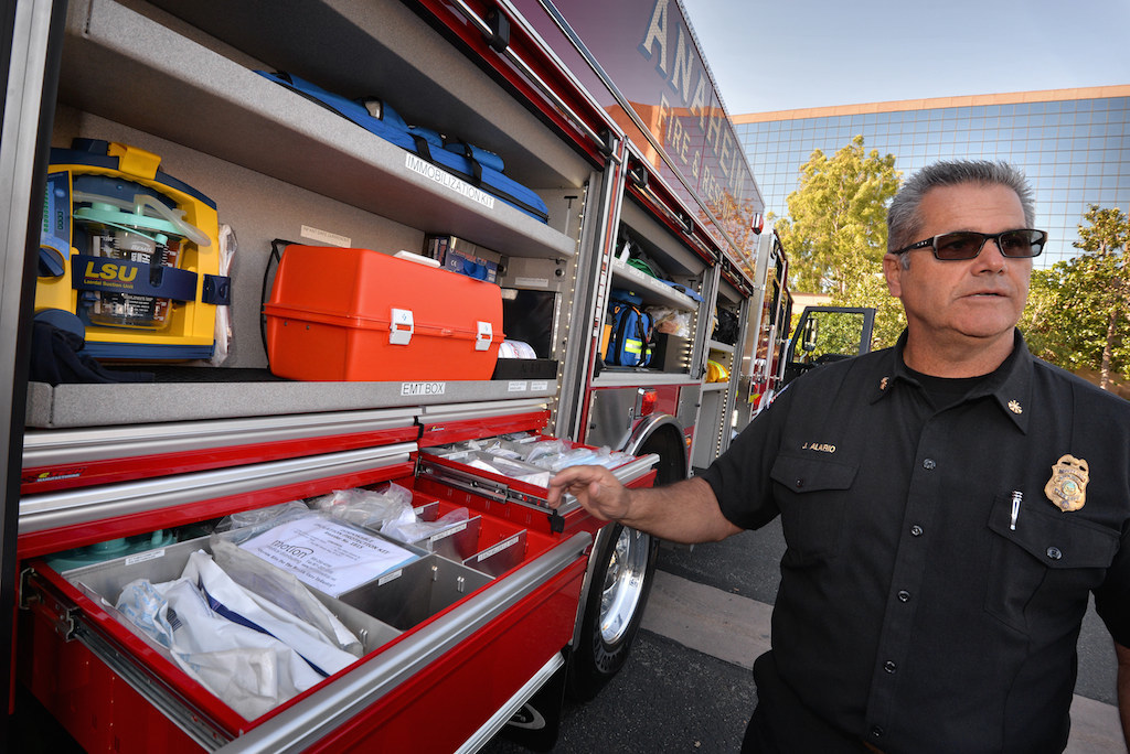 Jeff Alario, deputy chief of Support Services for Anaheim Fire & Rescue, talks about the better organized and more sanitary compartments for medical supplies in the department’s newest engine, Anaheim Fire Engine 1. Photo by Steven Georges/Behind the Badge OC