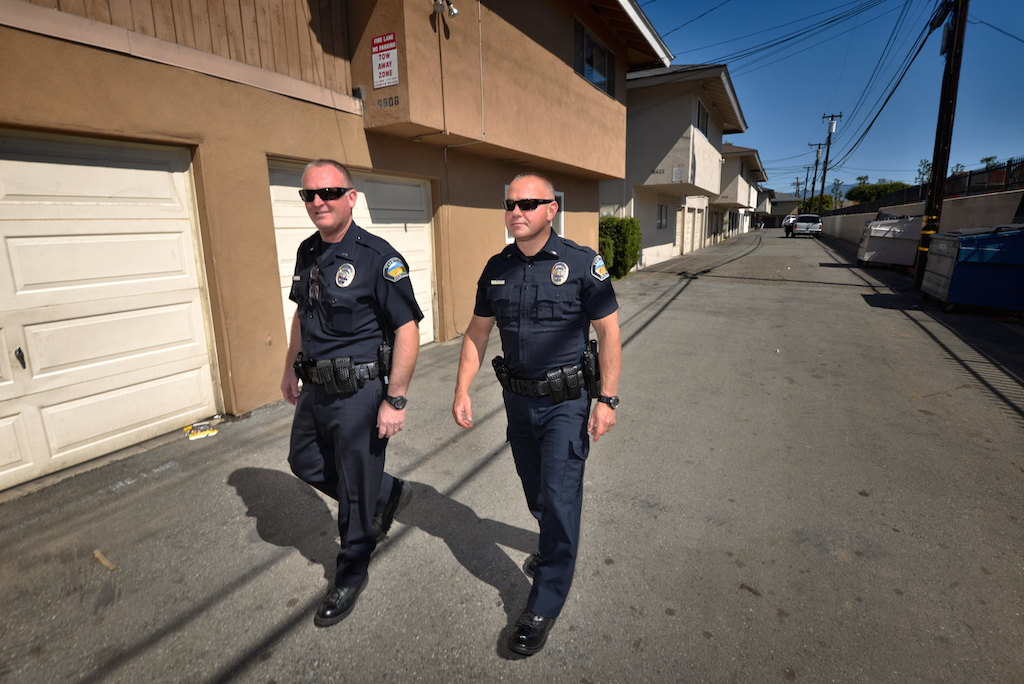 Lt. Todd Bullock, left, and Lt. Jeff Blair of the Tustin PD’s gang unit walk down what is called The Alliance Alley. Photo by Steven Georges/Behind the Badge OC