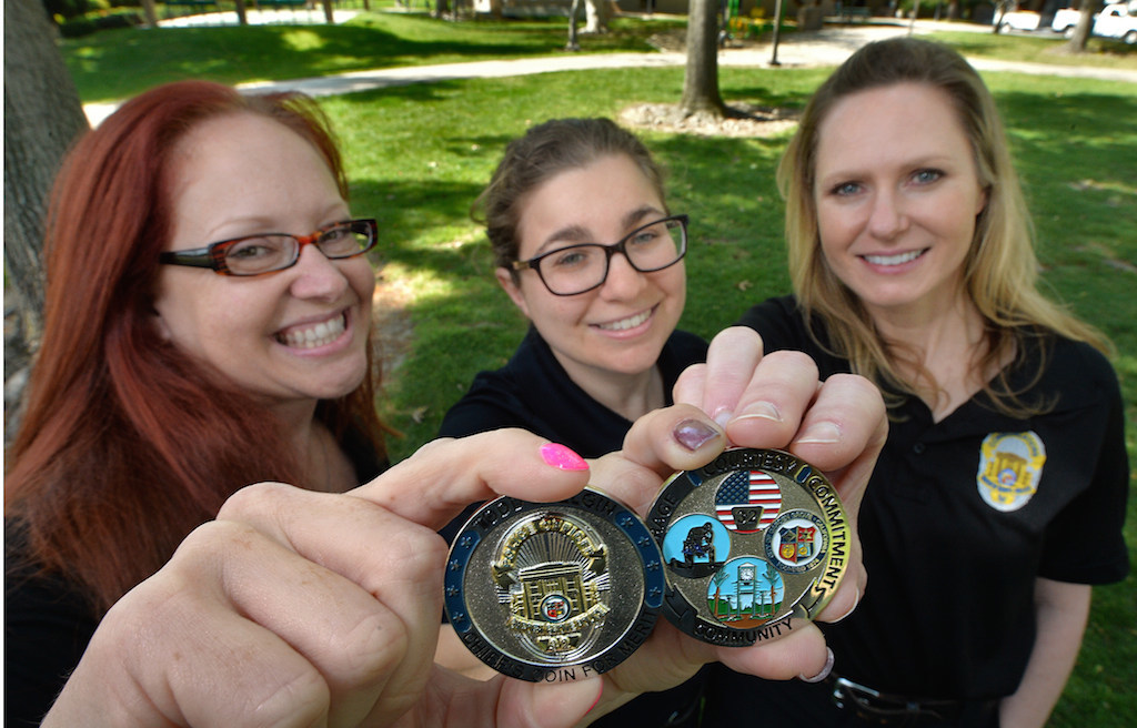 The three Garden Grove employees who designed the new Garden Grove PD’s Chief Coin are Dispatcher Susan Seymour, left, with Ashley Serota and Cheryl Whitney, right. Serota and Whitney used to work in the Records Department together. Serota still is in Records and Whitney now is a dispatcher. Photo by Steven Georges/Behind the Badge OC