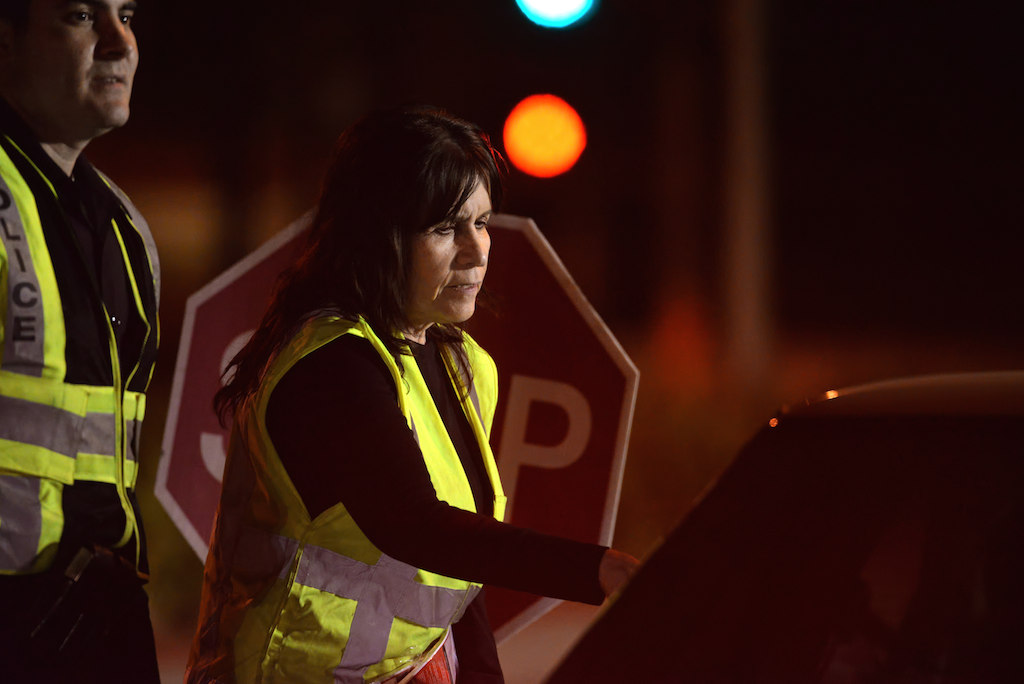 Haze Saliture, 16-year-old daughter Allison was killed by a drunk driver more than 20 years ago, volunteers at a Garden Grove DUI checkpoint handing out pamphlets about the dangers of driving under the influence. Photo by Steven Georges/Behind the Badge OC