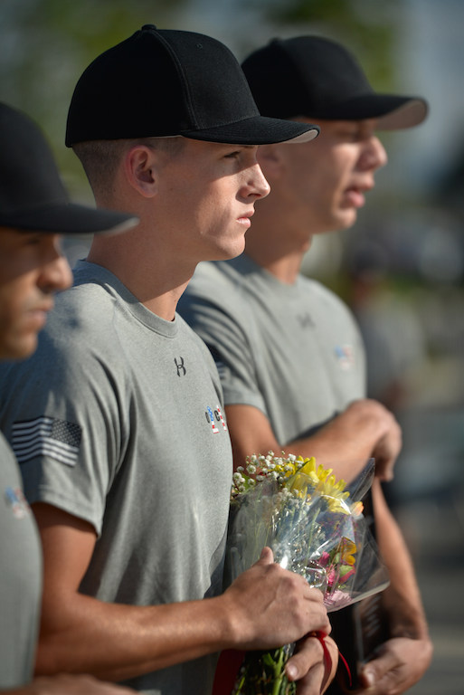 John Yergler, son of Lori Yergler and retired Garden Grove PD Officer John Yergler, holds the flowers he will give to his mother during a last training ceremony for his class at the Orange County Sheriff's Regional Training Academy in Tustin. His class was dedicated to his mother’s first husband, Garden Grove PD Officer Michael Rainford who was killed by a drunk driver before John was born. Photo by Steven Georges/Behind the Badge OC