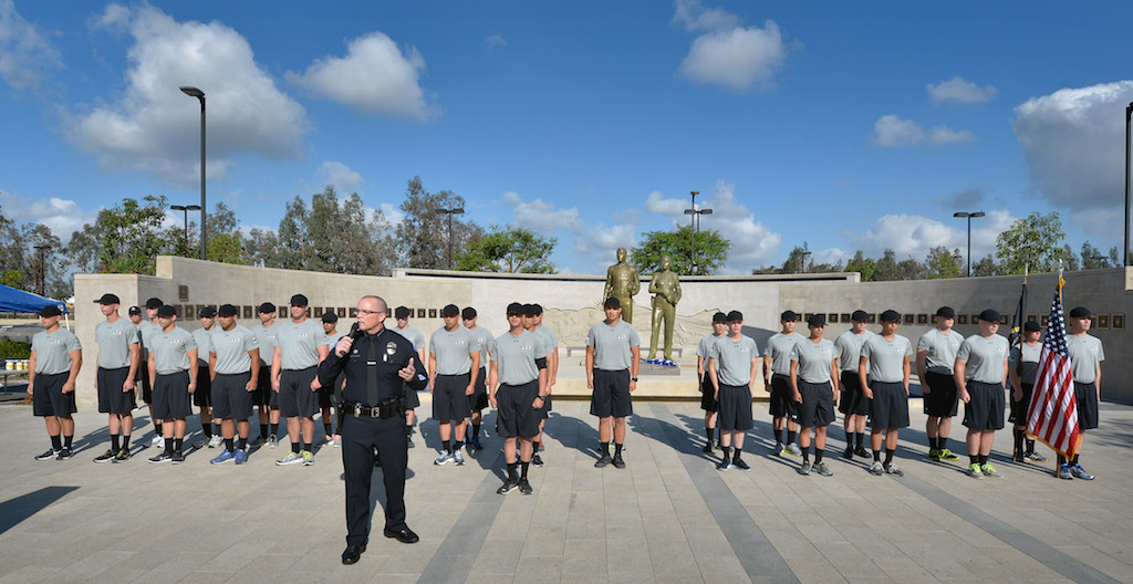 Grove Police Chief Todd Elgin says a few words to a class of police cadets about to graduate at the Orange County Sheriff's Regional Training Academy in Tustin during a last training day ceremony. The class is being dedicated to Garden Grove PD Officer Michael Rainford who was killed by a drunk driver. Photo by Steven Georges/Behind the Badge OC