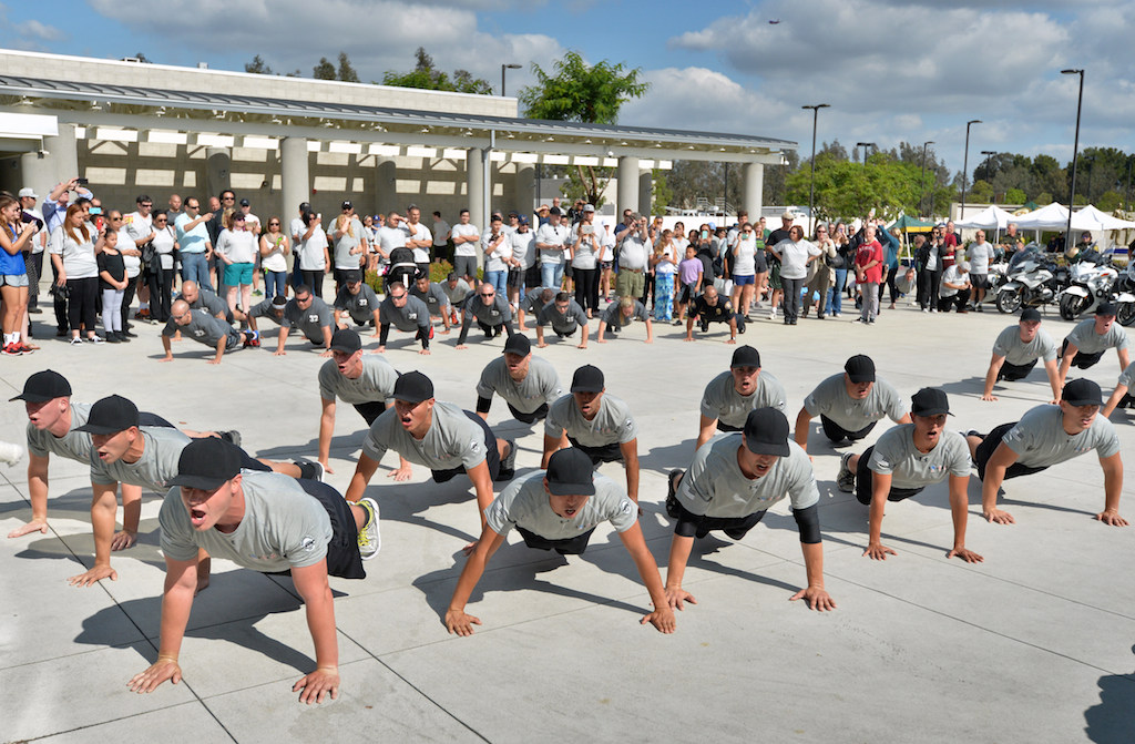 Police cadets perform pushups as their family and friends watch behind them at the Orange County Sheriff's Regional Training Academy in Tustin on the last day of training before graduation. Photo by Steven Georges/Behind the Badge OC