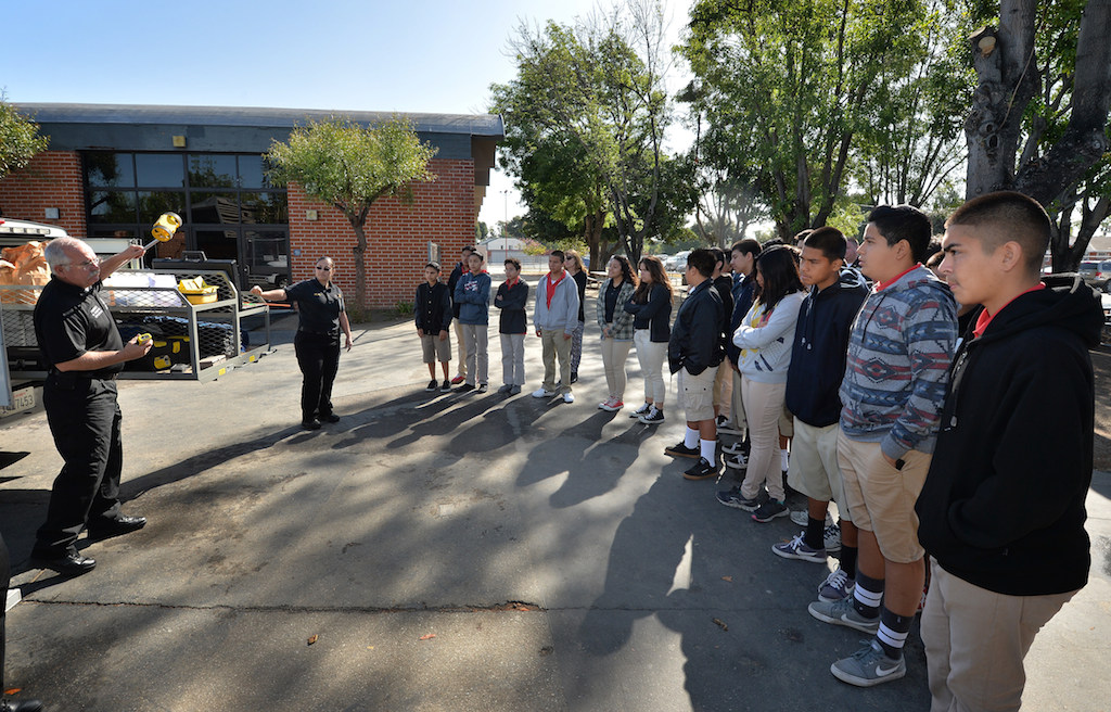 Forensic Supervisor Mark Sveinson of Anaheim PD shows kids from Sycamore Junior High the tools they use to gather evidence at a crime scene. Photo by Steven Georges/Behind the Badge OC
