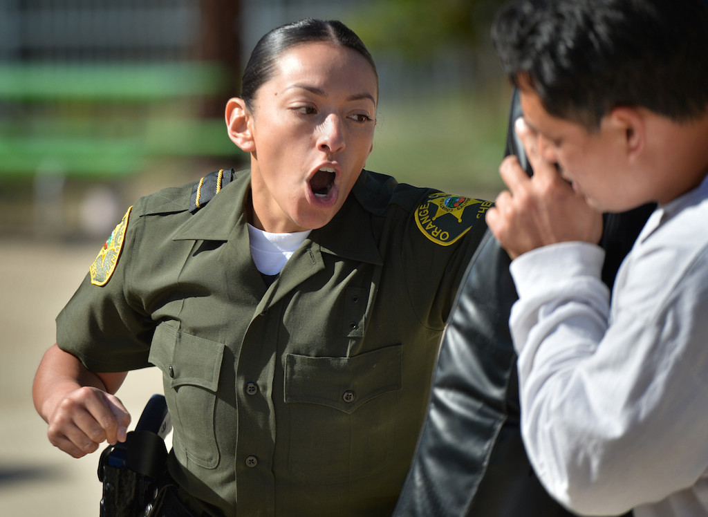 Orange County Sheriff Recruit Margarita Alatore punches a simulated suspect during an exhausting Will to Survive test at the OC Sheriff Training Academy in Tustin. Photo by Steven Georges/Behind the Badge OC