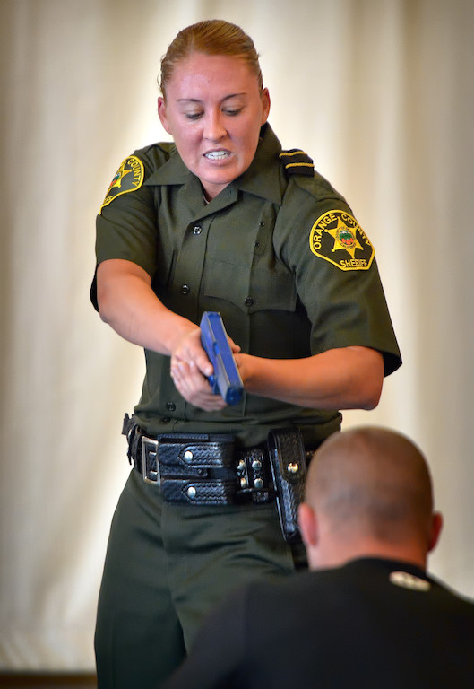 Orange County Sheriff Recruit Danielle Patrick orders a suspect to the ground with a simulated blue gun after wrestling with him during an exhausting Will to Survive test at the OC Sheriff Training Academy in Tustin. Photo by Steven Georges/Behind the Badge OC