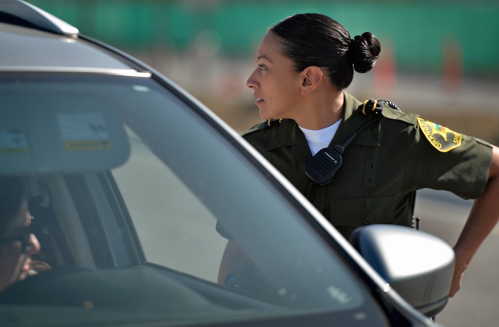 Orange County Sheriff Recruit Margarita Alatore questions a suspect inside a car during the Will to Survive test at the OC Sheriff Training Academy in Tustin. Photo by Steven Georges/Behind the Badge OC