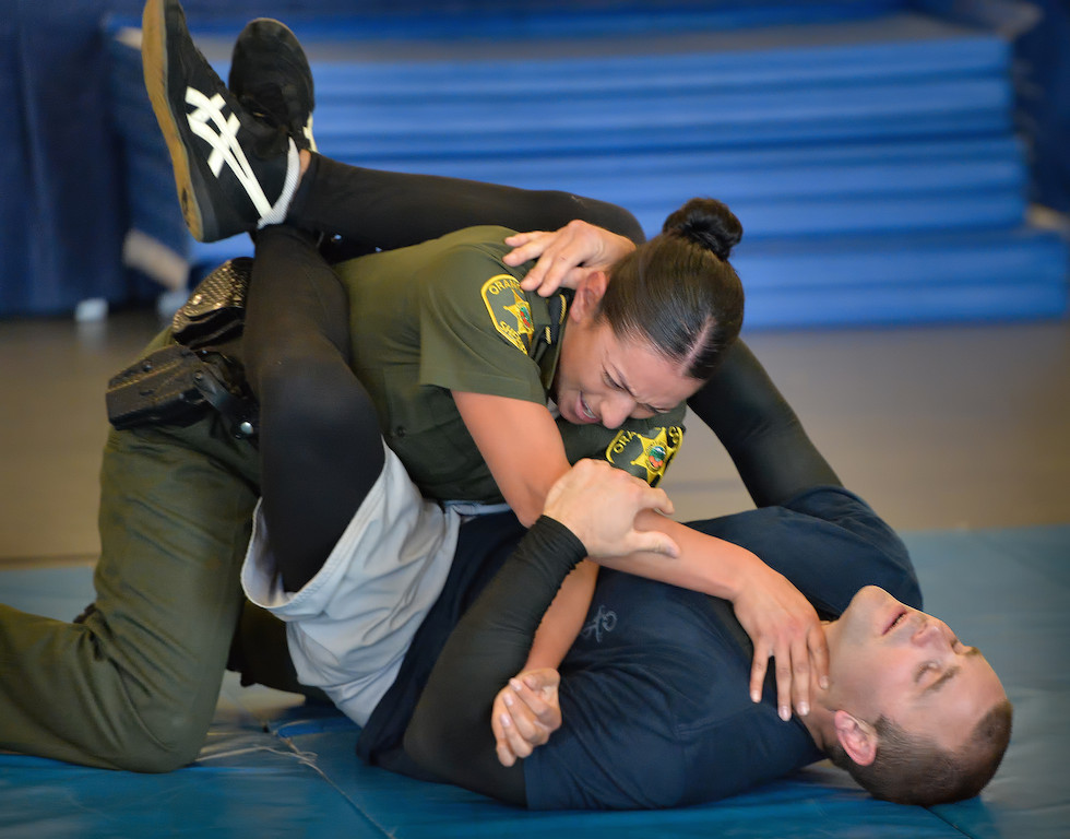 Orange County Sheriff Recruit Margarita Alatore wrestles with a suspect during an exhausting Will to Survive test at the OC Sheriff Training Academy in Tustin. Photo by Steven Georges/Behind the Badge OC