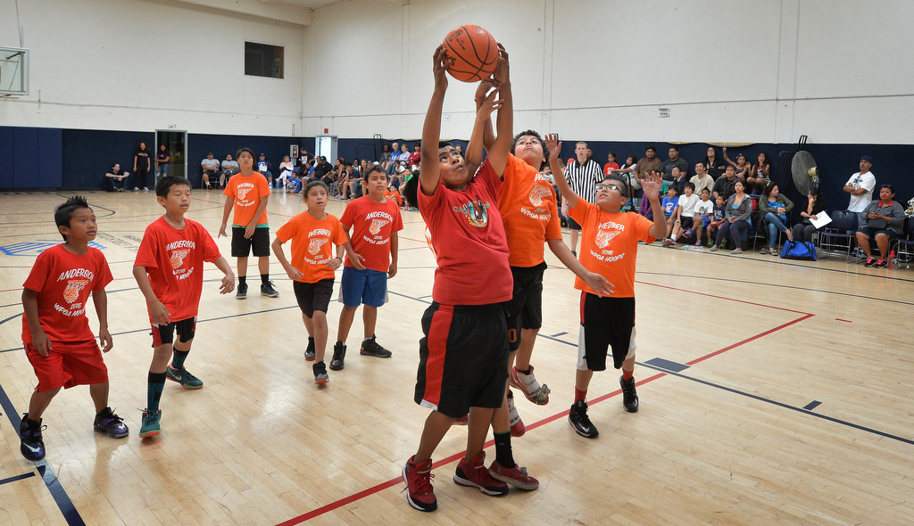 Andy Vasconcelos of team Anderson, left, and Erick Gutierrez of team Webber leap for a rebound during the Hoops Basketball League championship game sponsored by the Westminster Police Officer's Association. Gutierrez scored 4 points in the game and Vasconcelos scored 2. Photo by Steven Georges/Behind the Badge OC
