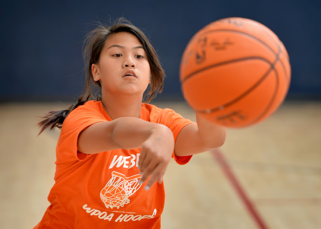 Honey Nguyen of team Webber passes the ball during the Hoops Basketball League championship game sponsored by the Westminster Police Officer's Association. Nguyen scored 2 points in the game. Photo by Steven Georges/Behind the Badge OC