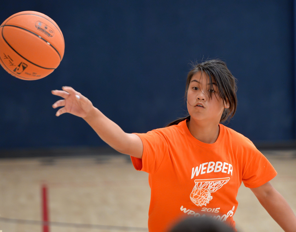 Honey Nguyen of team Webber passes the ball to an open teammate during the Hoops Basketball League championship game sponsored by the Westminster Police Officer's Association. Nguyen scored two points in the game. Photo by Steven Georges/Behind the Badge OC