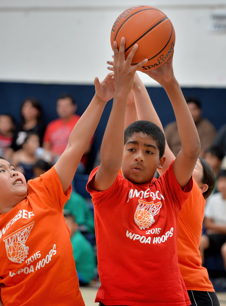 Kennedy of team Webber, left, and Henry Booth of team Anderson reach for a rebound during the Hoops Basketball League championship game sponsored by the Westminster Police Officer's Association. Photo by Steven Georges/Behind the Badge OC