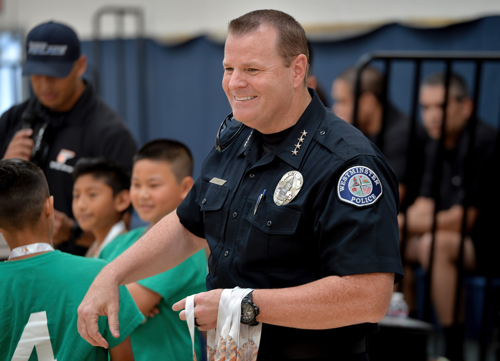 Westminster Police Chief Kevin Baker gets ready to hand out medals to kids at the Boys & Girls Club of Westminster during the start of the Hoops Basketball League awards ceremony sponsored by the Westminster Police Officer's Association. Photo by Steven Georges/Behind the Badge OC