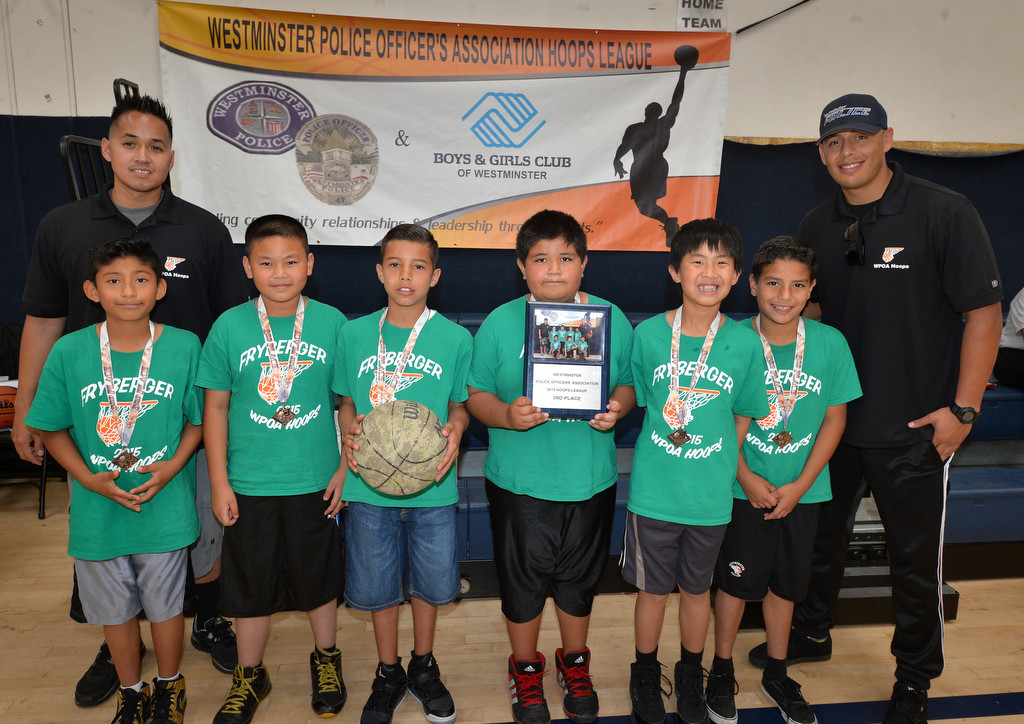 Players and coaches from team Fryberger gather after taking third place for the Westminster Police Officer's Association’s 2015 Hoops Basketball League championship at the Boys & Girls Club of Westminster. Photo by Steven Georges/Behind the Badge OC