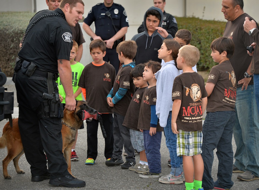 Officer Jonathan Miller of the Fullerton PD shows his police dog Mueller to kids from Adventure Guides as they take a tour of the Fullerton Police Department. Photo by Steven Georges/Behind the Badge OC