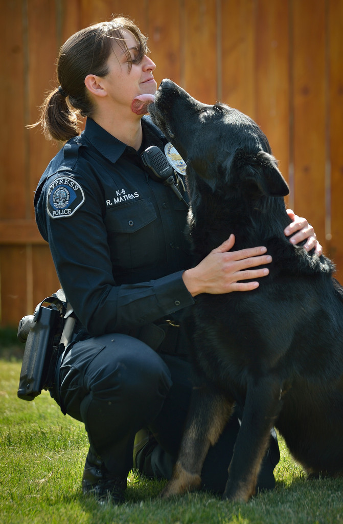 Cypress PD Officer Becky Mathias with her K-9 partner Sem. The German Shepherd was injured by a suspect during a pursuit and is now at home recovering. Photo by Steven Georges/Behind the Badge OC