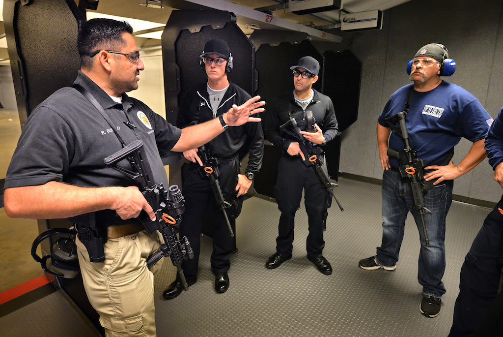 Sgt. Richard Burillo, range master with the Garden Grove PD, left, runs through the upcoming training session with new Garden Grove police recruits and fire department arson investigators during firearm certification at Field Time Target & Training shooting range in Stanton. Photo by Steven Georges/Behind the Badge OC