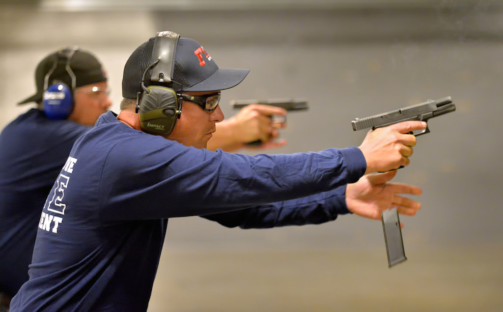 Garden Grove Fire Arson Investigators Bill Strohm, front right, and Mike Jacobs behind him, runs through speed reload drills with Glock 45 caliber handguns during certification training at Field Time Target & Training shooting range in Stanton. Photo by Steven Georges/Behind the Badge OC
