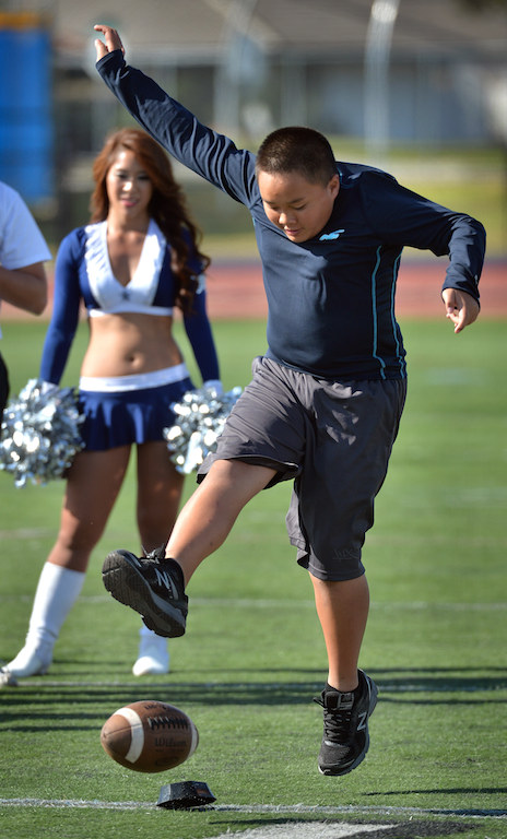 Kyle Ly participates in a half time kicking competition during Freedom Bowl II benefiting Special Olympics Southern California. Photo by Steven Georges/Behind the Badge OC