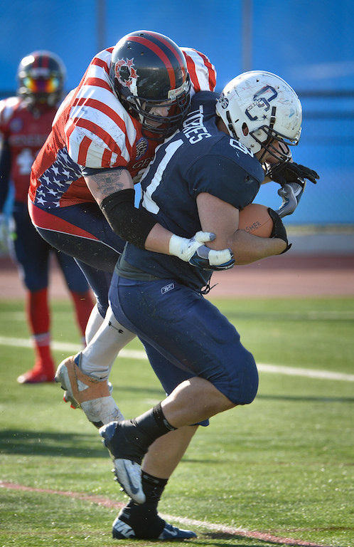 DC Generals’ Chris Gozdziewski (51) tries to take down OC Lawmen Nelson Torres (41) of OCSD before Torres breaks free to score a touchdown during Freedom Bowl II at Bradford Stadium. Photo by Steven Georges/Behind the Badge OC