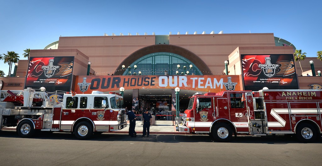 Anaheim Fire & Rescue park Truck 6, left, and Engine 5 arrive at the Honda Center ready to “Extinguish The Flames” as the Anaheim Ducks host the Calgary Flames for Game 1 of the second-round NHL playoff series in Anaheim. Photo by Steven Georges/Behind the Badge OC