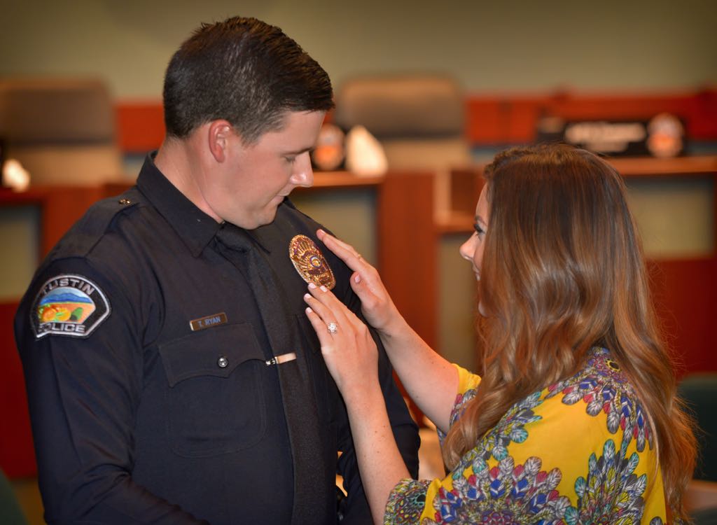 Tustin Reserve Officer Taylor Ryan has his badge pinned to him by his fiancee Danielle Frizelle during a Tustin PD swearing in ceremony. Photo by Steven Georges/Behind the Badge OC